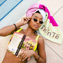 Load image into Gallery viewer, Woman laying by the pool wearing SkinTē Green Tea Grapefruit Beach Towel wrap